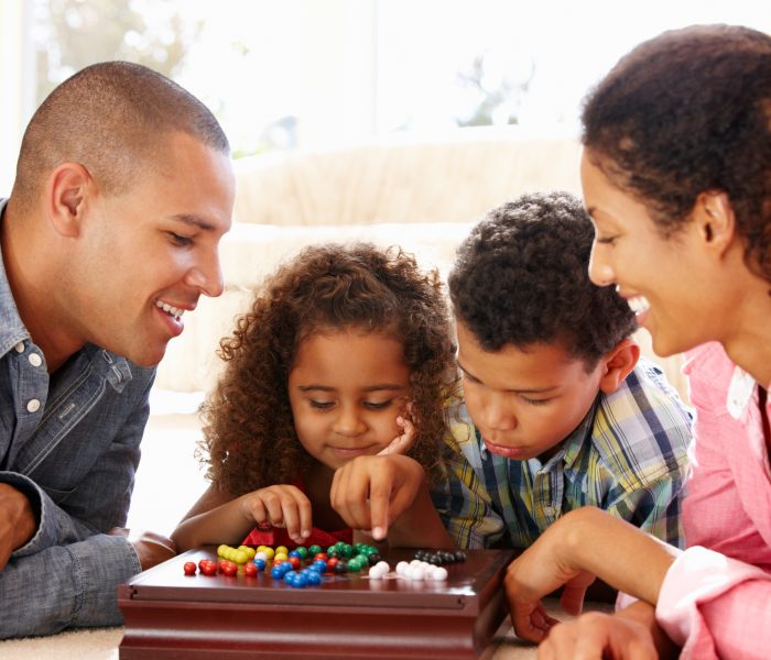 Mixed race family playing solitaire